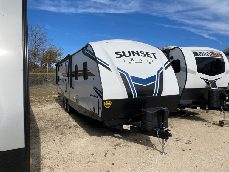 Travel trailer hitched to Orange Gator RV Transport truck for delivery in Oklahoma.