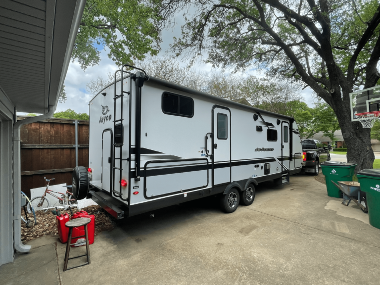 Travel trailer connected to truck, ready for transport in North Texas.