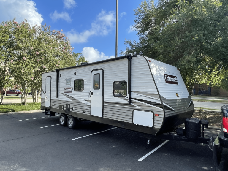 Travel trailer secured for transport by Orange Gator RV Transport team.